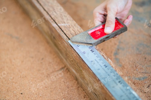 Preview: Woodworker Measures Wood with Steel Ruler and Square