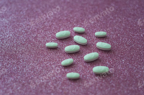 Preview: white pills on a pink glittery background