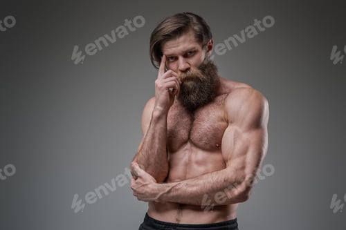 Preview: Shirtless guy with athletic body looks at camera posing in studio