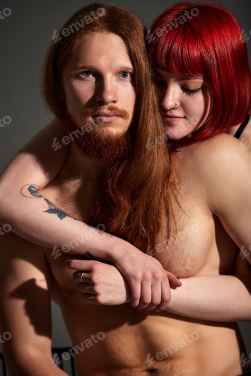 Preview: Studio portrait of sexy passionate couple in love. The hands of a woman embrace a handsome half