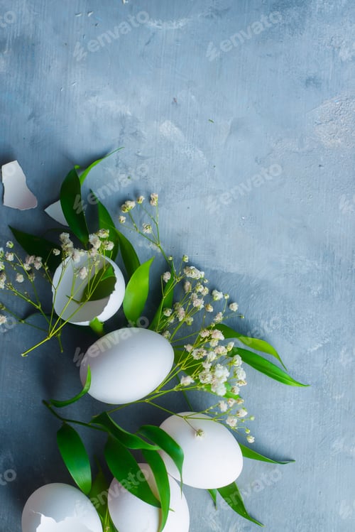 Preview: Overhead Easter background with white eggs, decorative green leaves and spring flowers. Organic