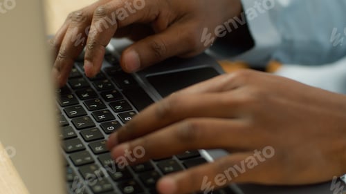Preview: Unrecognizable biracial businessman student working studying with computer pc at table close up male