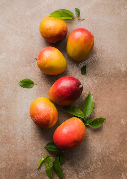 Preview: Mango background design concept. Top view of fresh mango fruit pattern with leaves on table.