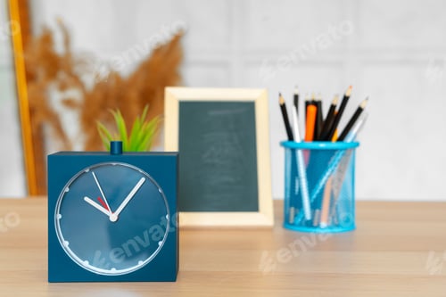 Preview: Office interior details with alarm clock and stationery items
