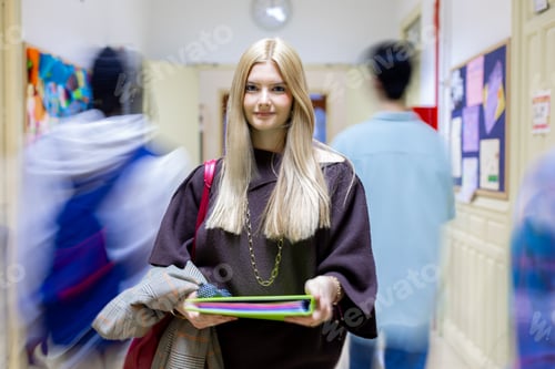 Preview: Female student standing in busy school hallway