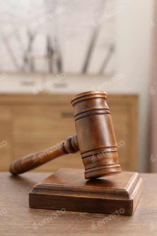 Preview: Wooden gavel and sound block on table indoors, closeup. Space for text