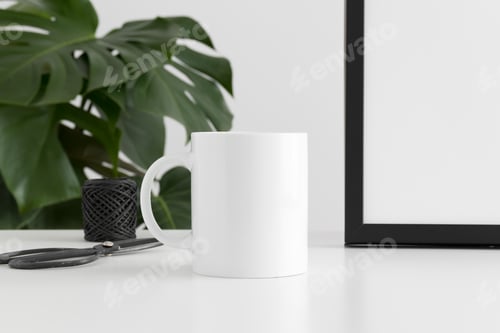 Preview: Mug mockup with workspace accessories and a monstera plant.