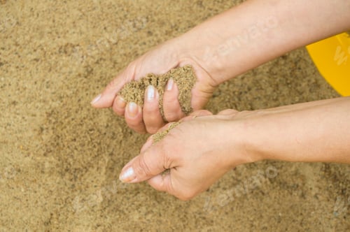 Preview: Female hands with sand, the concept of vacation and holidays