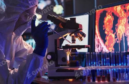 Preview: Scientist in white protective uniform near displays with data works with coronavirus and blood tubes