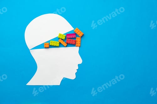 Preview: Papercut silhouette of human head with colorful constructor pieces