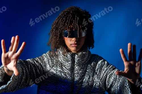 Preview: Young trendy woman wearing futuristic visor and pushing virtual screen