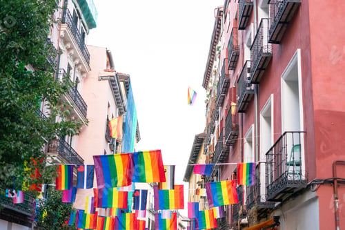 Preview: Rainbow flags hanging between buildings celebrating gay pride