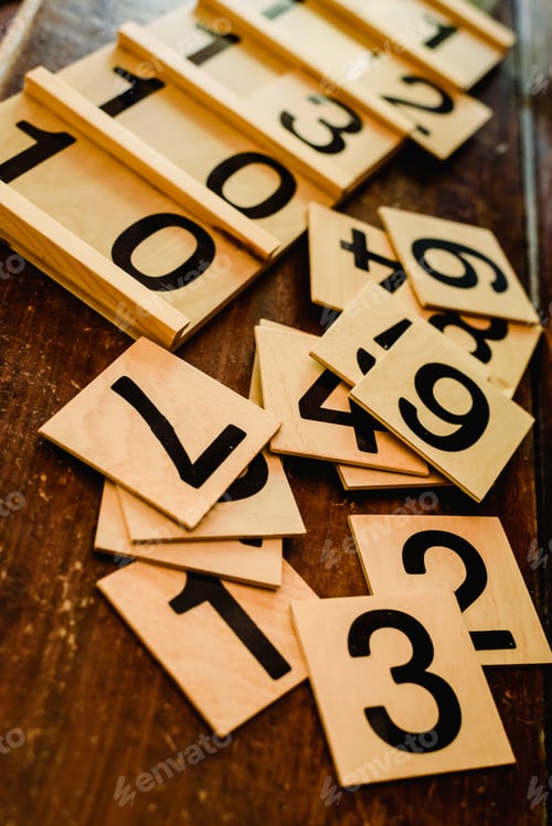 Preview: Wooden numbers in tables to learn mathematics in a Montessori classroom.