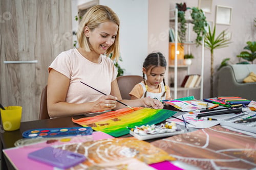 Preview: Mother and daughter enjoying a creative painting session at home