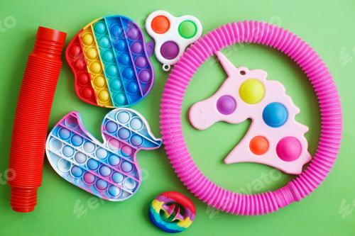 Preview: colorful antistress sensory fidget toys on a green background.