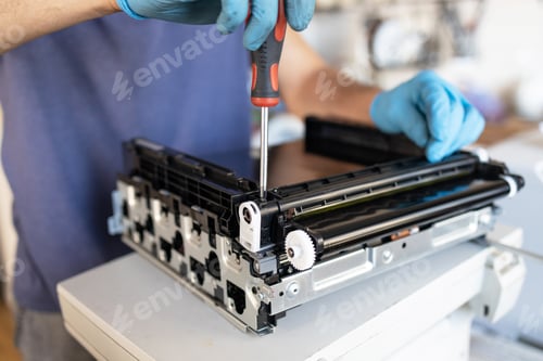 Preview: Close-up of a man repairing a photocopier in his office