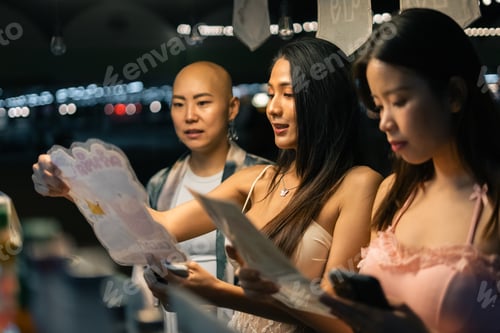 Preview: Asian women friends enjoying night market lifestyle in bangkok, shopping and choosing