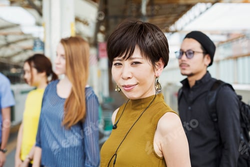 Preview: Small group of people standing on the platform of a subway station, Tokyo commuters.