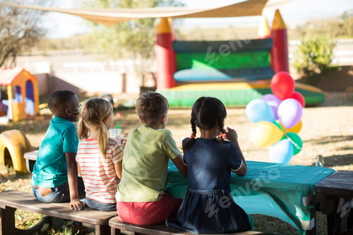 Preview: Children sitting on bench at park