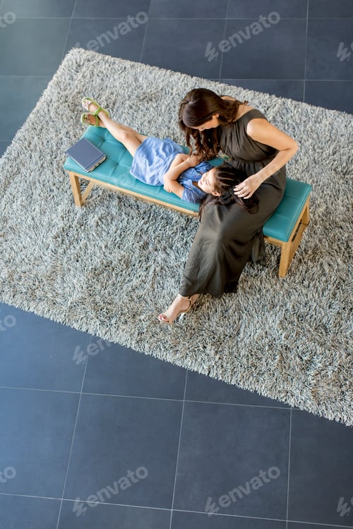 Preview: Little daughter lay on her mother's lap and enjoy, view from above