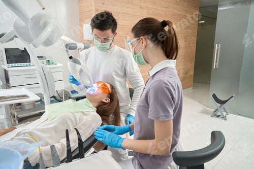 Preview: Stomatologist conducting dental procedure on young woman