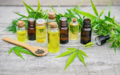 Preview: Cannabis oil in a small bottle. Selective focus.