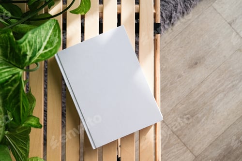 Preview: blank book mockup on decorative table with many green plants