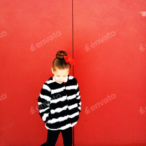 Preview: Girl against red wall dressed in faux fur winter coat