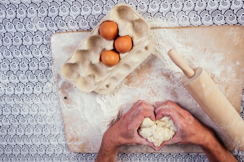 Preview: The male hands in flour and rustic organic loaf of bread prepares to make the bio