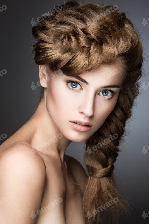 Preview: Beautiful girl with light make-up, perfect skin and hairstyle as a braid.Picture taken in the studio