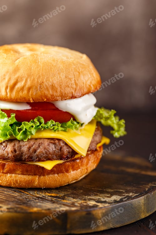 Preview: Close-up of home made tasty burger on wooden table.