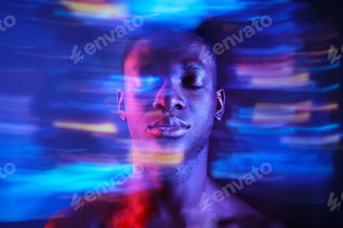 Preview: Black man with eyes closed in blurred blue lights