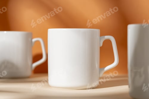 Preview: White ceramic mugs on peach background with shadows