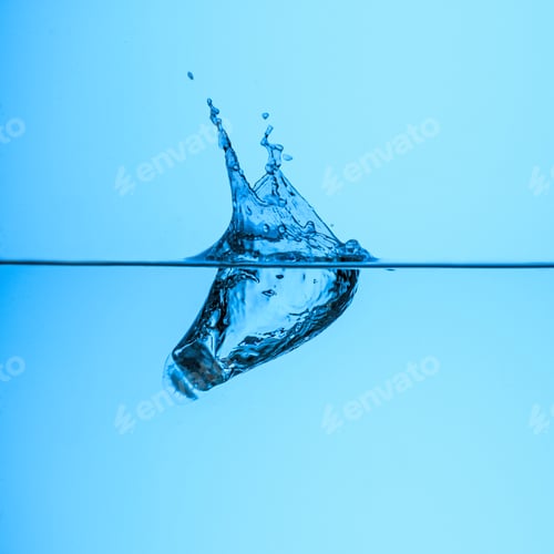 Preview: ice cube in clear water, isolated on blue