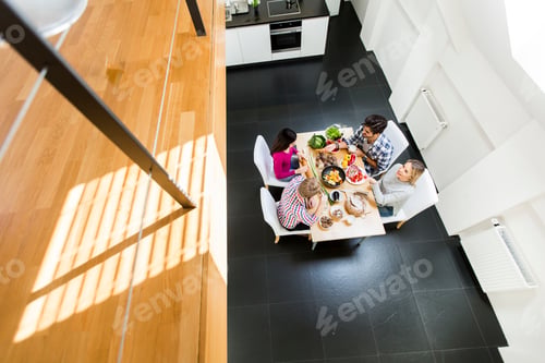 Preview: Young people having meal in the modern kitchen