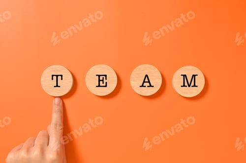 Preview: Hand pointing team word written on wooden blocks with abstract background, Business and teamwork
