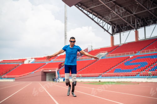 Preview: Asian para-athlete with prosthetic blades warms up body in the stadium.