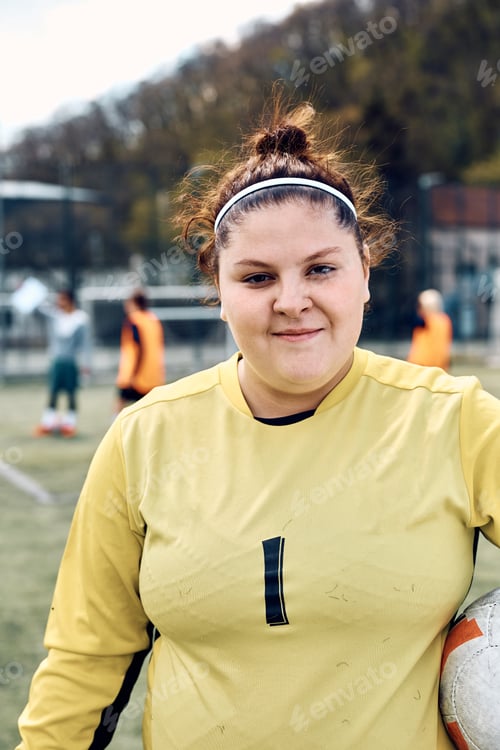 Preview: Portrait of female soccer goalkeeper looking at camera.