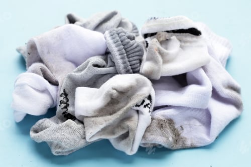 Preview: Dirty white socks on blue background.