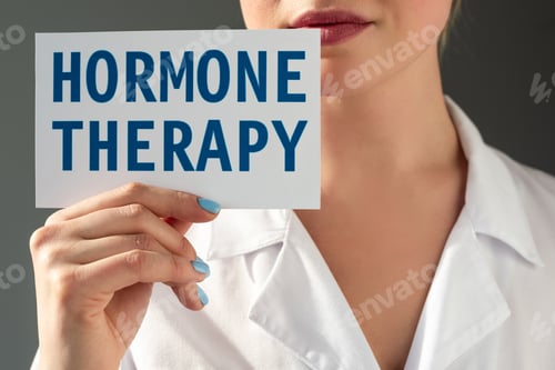 Preview: Cropped view of doctor holding card with hormone therapy lettering isolated on grey