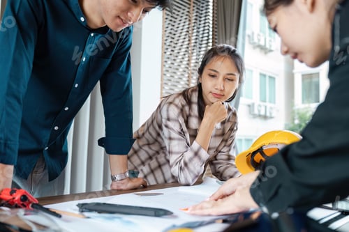 Preview: Group of Engineer collaboration on a Project in a Modern Office Setting with Blueprints and Safety