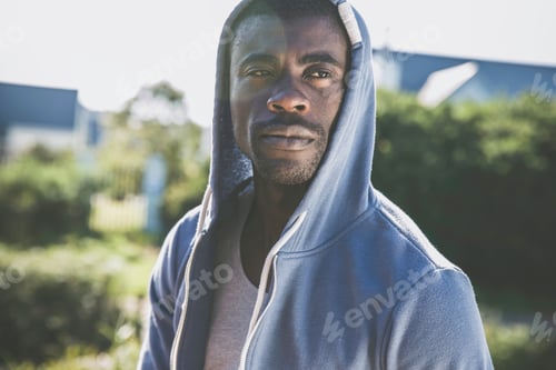 Preview: Portrait of man wearing hooded top looking away