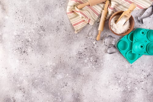 Preview: Baking accessories on stone background with flour. Easter preparation or baking sweets, flat lay