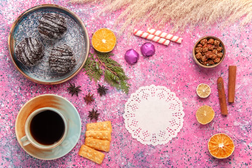Preview: top view chocolate cakes with cup of tea on light-pink background biscuit chocolate cake sweet pie