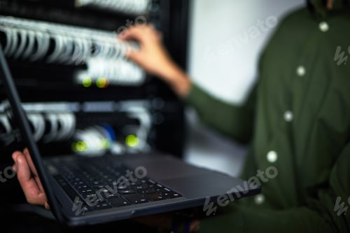 Preview: Server room maintenance, laptop and technician at work for cyber security and building network. Pro