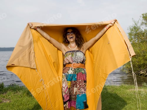 Preview: Woman laughing and standing under tent