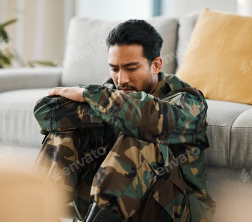Preview: Sad, trauma and male military soldier sitting on the floor in the living room of his house. Depress