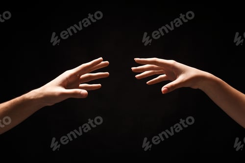 Preview: Hands of man and woman in love, isolated on black