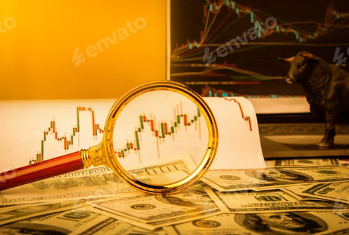 Preview: Magnifying glass on a diagram and paper money - accounting concept