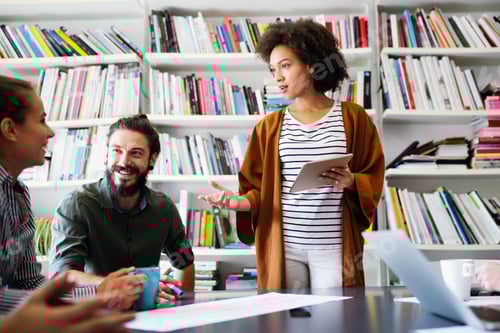 Preview: Working together on project. Happy young business colleagues working in office